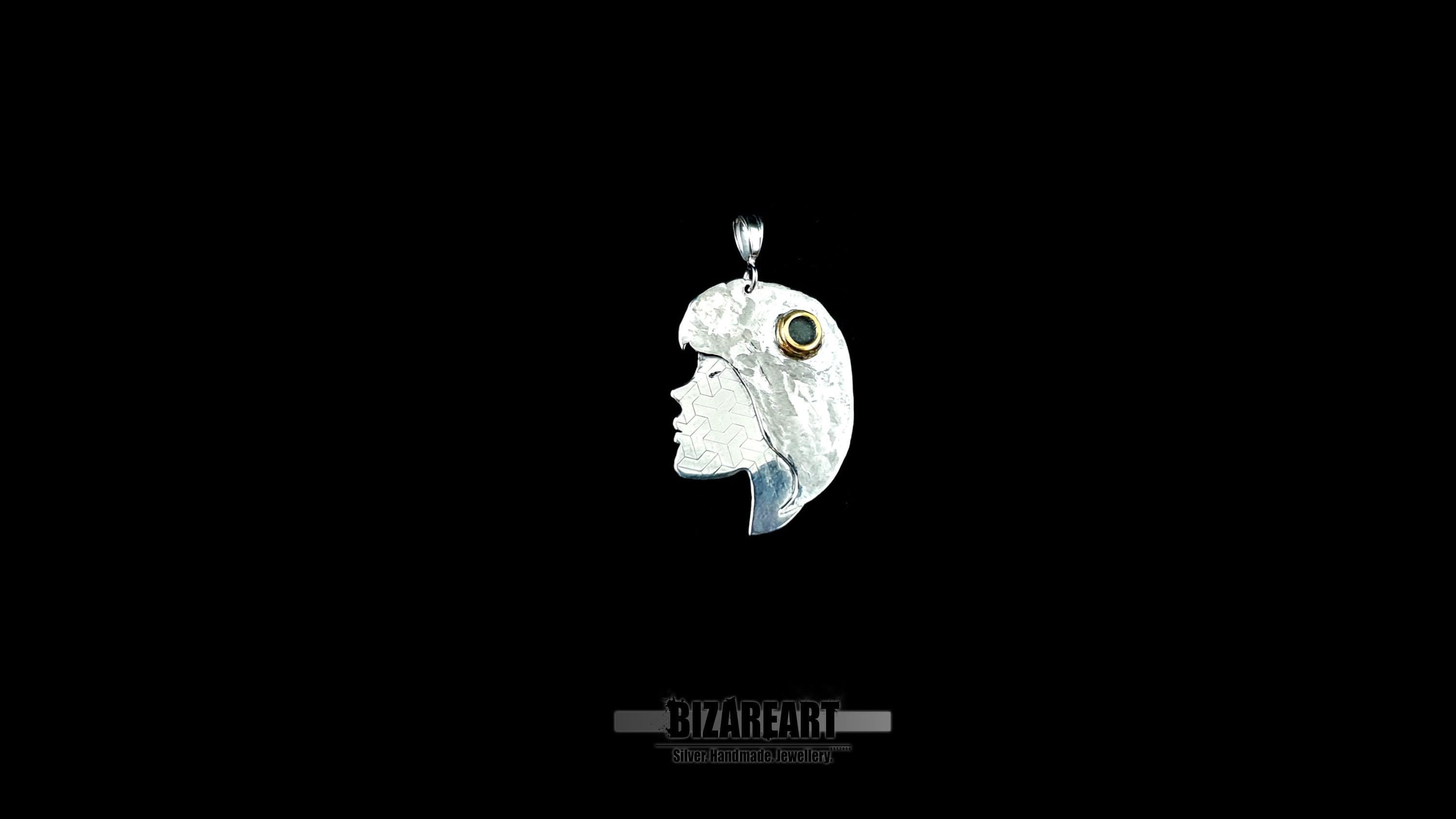 A clean, high-contrast studio shot of the silver portrait pendant centered against a solid black background.