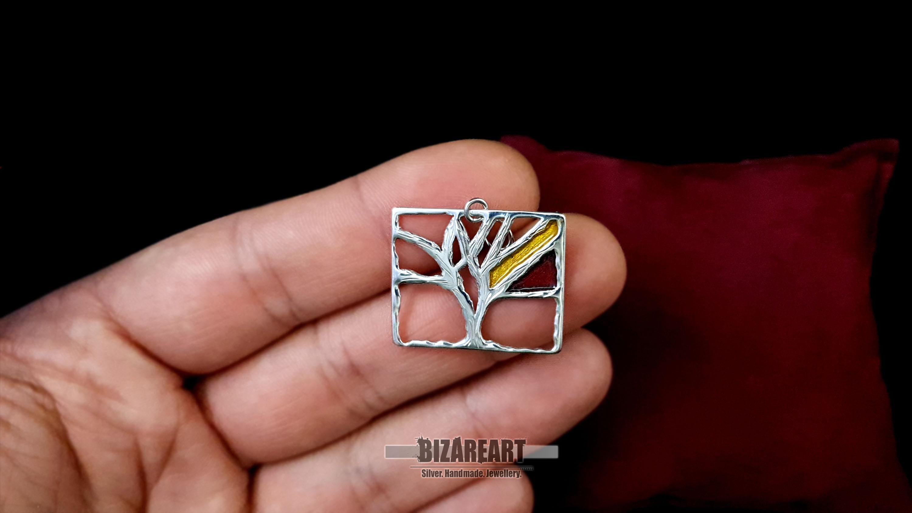 Hand held Solid of the Tree of Life pendant showing handcrafted quality and sizing