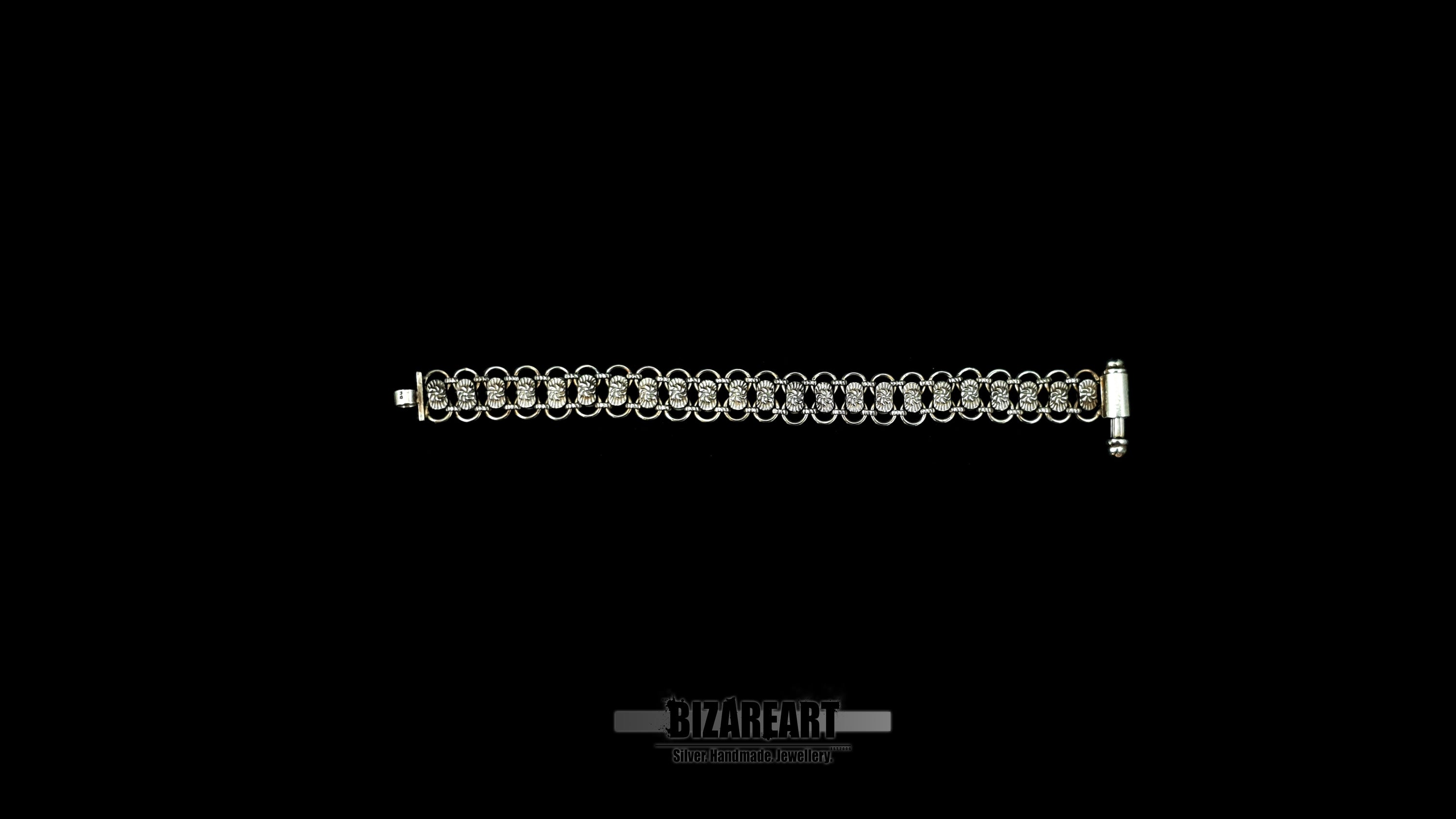 Full-length flat lay view of the Byzantium textured sterling silver link bracelet against a solid black background, showcasing the repeating link pattern.