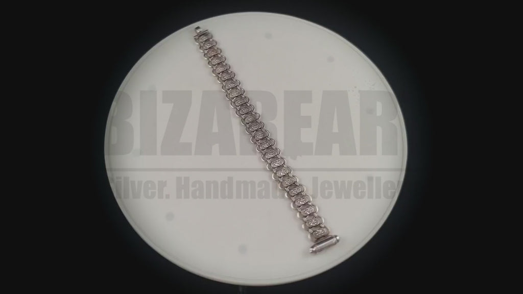 Rotating studio video of the Bizareart Byzantium sterling silver link bracelet, showcasing its fluid articulation, dense weight, and high-contrast patina.