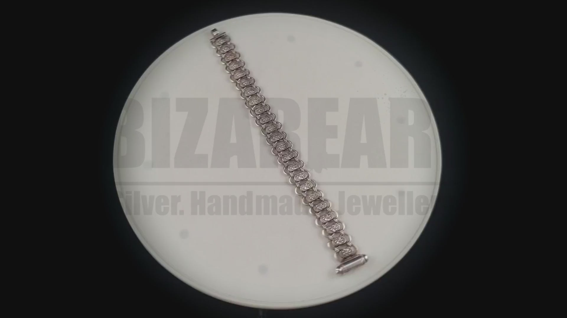 Rotating studio video of the Bizareart Byzantium sterling silver link bracelet, showcasing its fluid articulation, dense weight, and high-contrast patina.