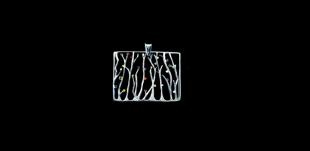 Video showing the 3D texture, polished finish, and reflective sparkle of the silver seaweed rectangular pendant necklace as it catches the light.