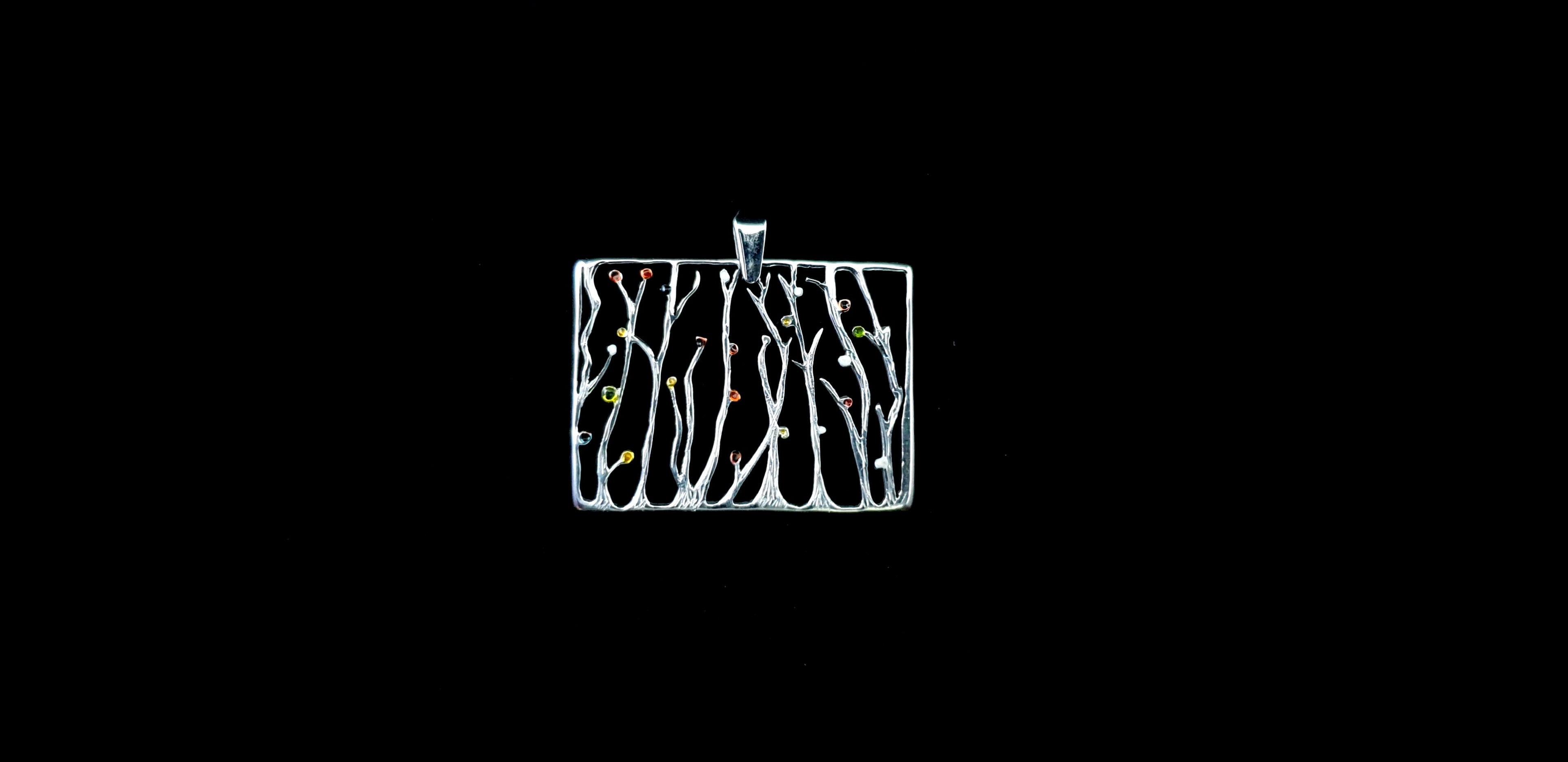 Video showing the 3D texture, polished finish, and reflective sparkle of the silver seaweed rectangular pendant necklace as it catches the light.