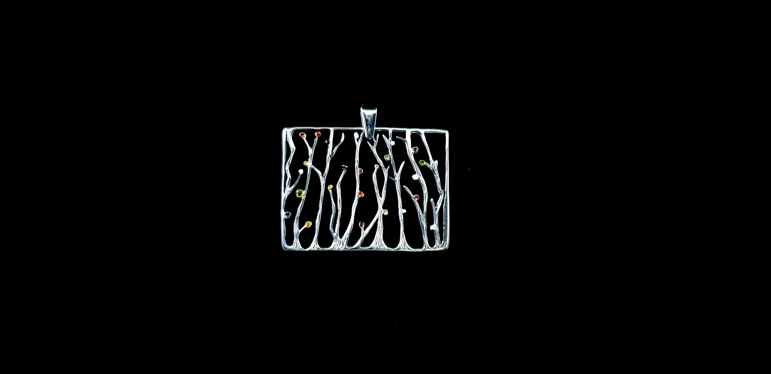 Video showing the 3D texture, polished finish, and reflective sparkle of the silver seaweed rectangular pendant necklace as it catches the light.