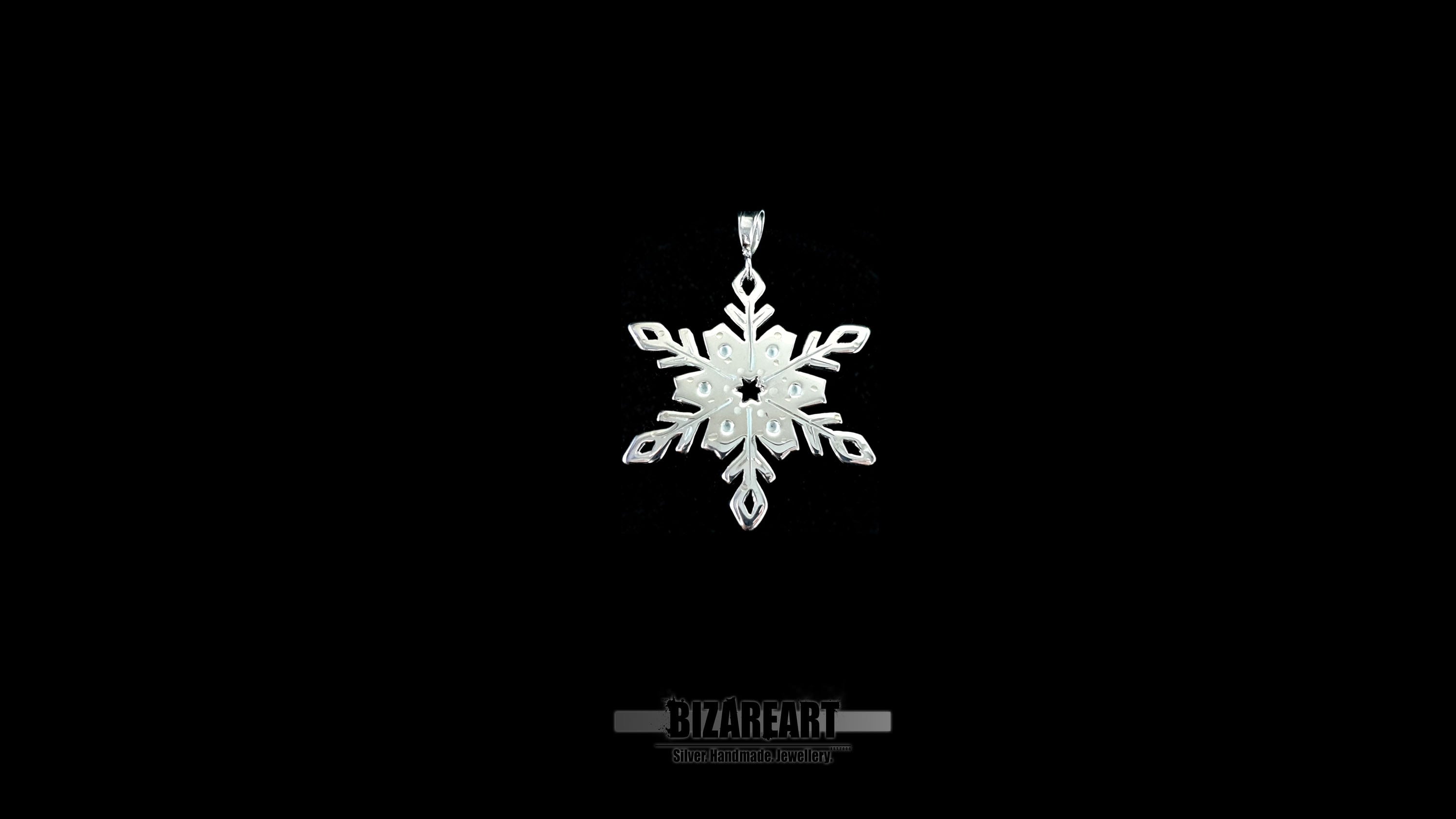 A video showcase of the one-of-a-kind snowflake pendant, rotating to catch the light and demonstrate the "wet look" shimmer of the liquid enamel detailing.