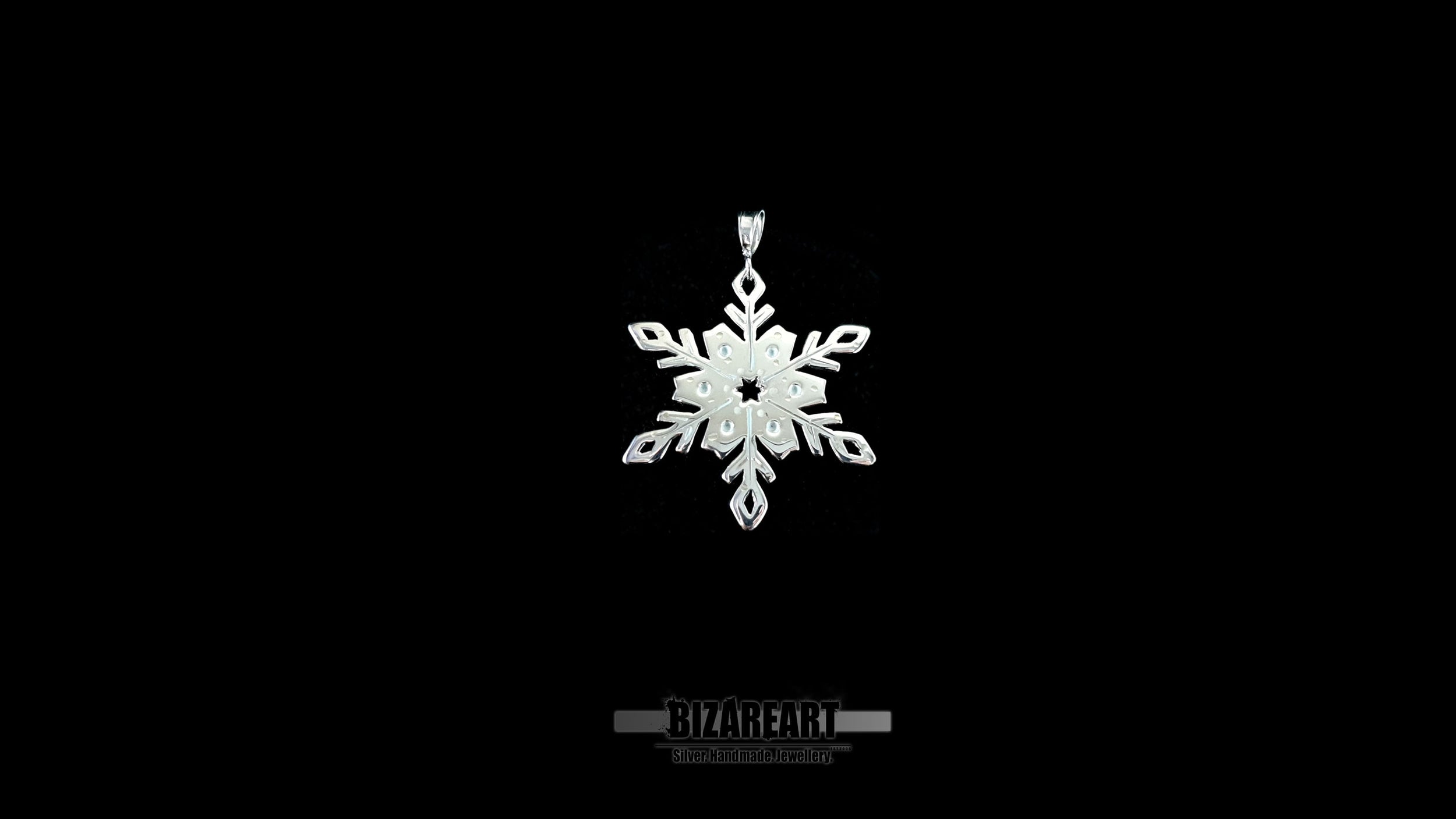 A video showcase of the one-of-a-kind snowflake pendant, rotating to catch the light and demonstrate the "wet look" shimmer of the liquid enamel detailing.